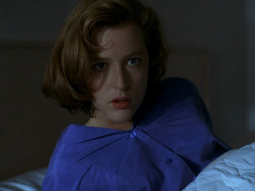 early series Scully sitting up in bed looking surprised
