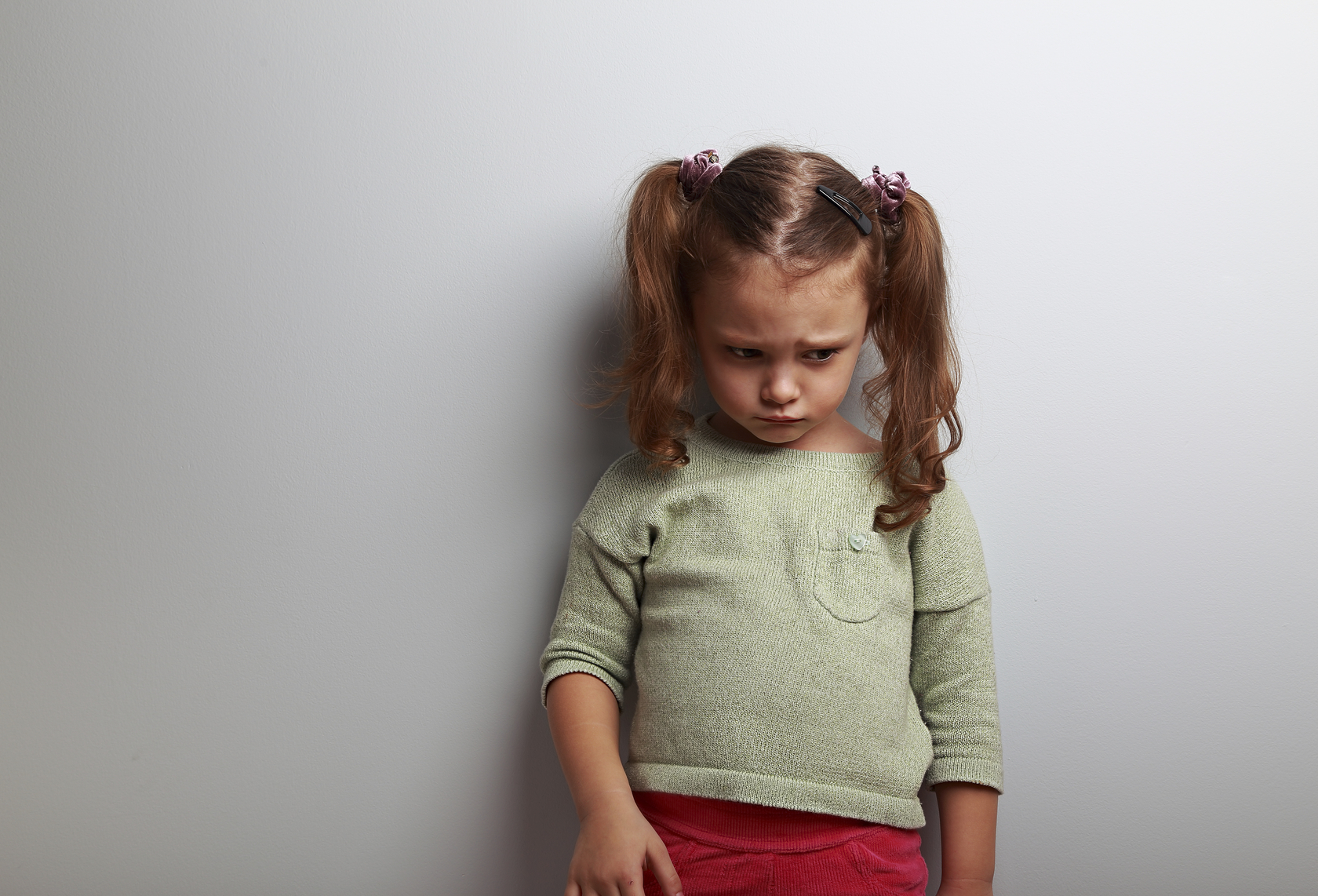 upset little girl looking down