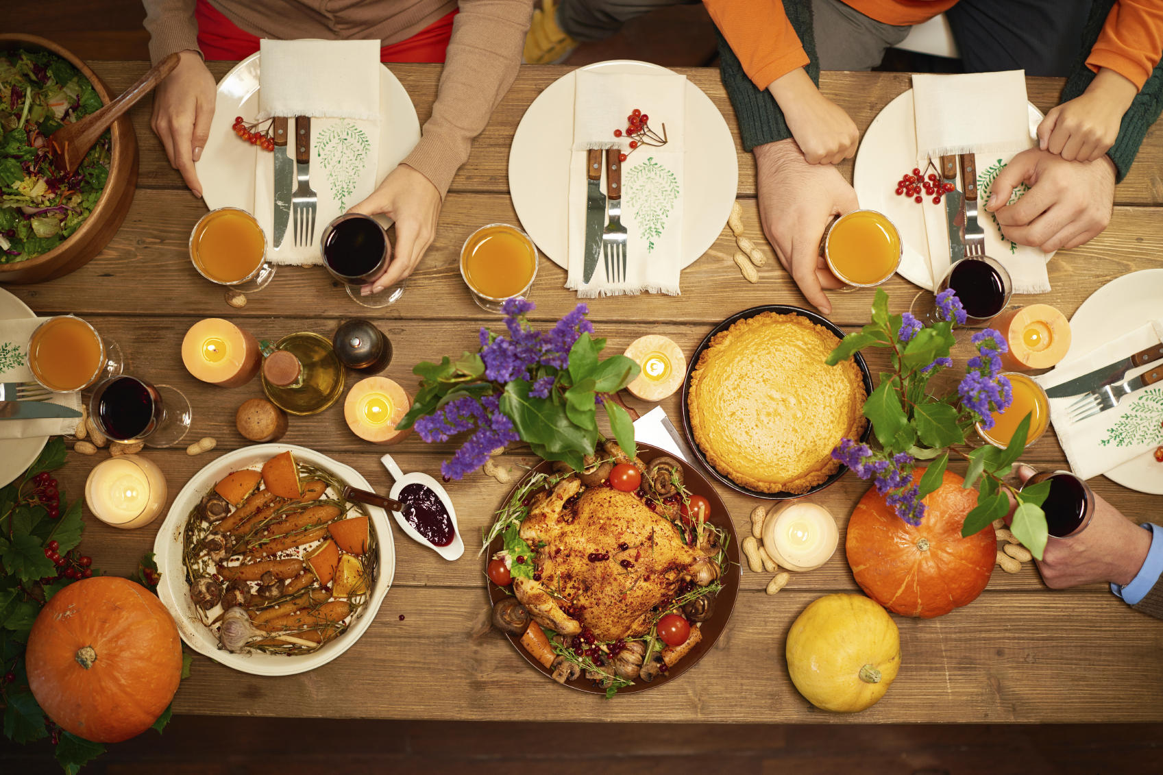 Thanksgiving table, people reaching for food